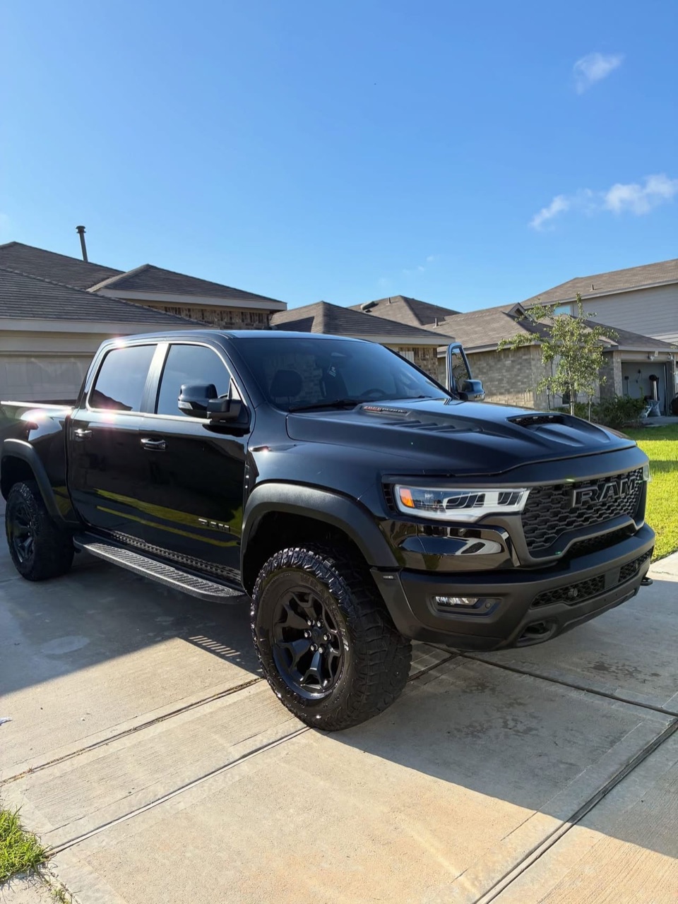Black RAM TRX after a full detail on a Houston driveway